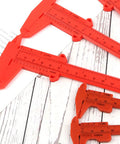 Depth Vernier Caliper Micrometer Gauge Measuring Tool, Multifunctional Depth Caliper for Measuring Length Tool Digital Gauge Vernier in bright red color on a wooden surface.
