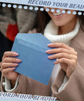 Person holding blue envelope from All In One Blue Letter Writing Paper And Envelope Set With 50 Lined Papers 50 Envelopes And 50 Stickers
