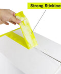 Heavy Duty Light Yellow Packing Tape Refills, 2.5 Mil Thick, sealing a box, showing strong adhesion