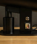 Close-up of switch and control features on the Killer Variable Speed Single Dose Coffee Grinder in glossy black.
