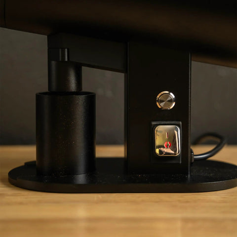 Close-up of switch and control features on the Killer Variable Speed Single Dose Coffee Grinder in glossy black.
