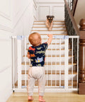 Child and dog separated by a Retractable Baby Gate For Stairs And Doorways, Extra Wide Fit From 29 To 40.5 Inches, 30 Inch Tall