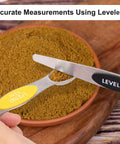 Magnetic Dual Sided Stainless Steel Measuring Spoons Set 7 Piece With Leveler in use on spices for accurate measurements.