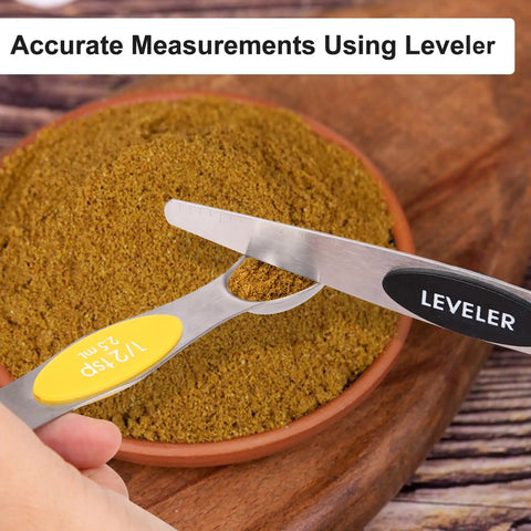 Magnetic Dual Sided Stainless Steel Measuring Spoons Set 7 Piece With Leveler in use on spices for accurate measurements.