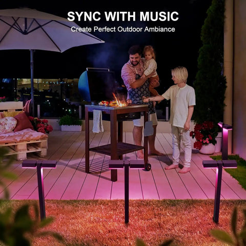 Family enjoying barbecue illuminated by Low Voltage Outdoor LED RGBW Landscape Lights 12V 8W, 400LM Smart Path Lights.