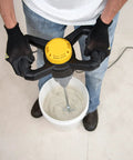 Person using 120 Volt 2 Speed Power Mixer With Mixing Paddle For Thinset Mortar And Grout in a bucket