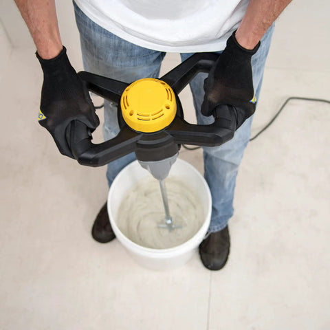 Person using 120 Volt 2 Speed Power Mixer With Mixing Paddle For Thinset Mortar And Grout in a bucket