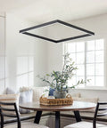 Sleek Black Square Chandelier With Up Light And Down Light For Kitchen Island And Dining Room over dining table.