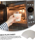 Person using a microwave with 12 Pack Microwave Mica Sheet Waveguide Cover Replacement Plate Heat Resistant Insulation Easy To Cut.