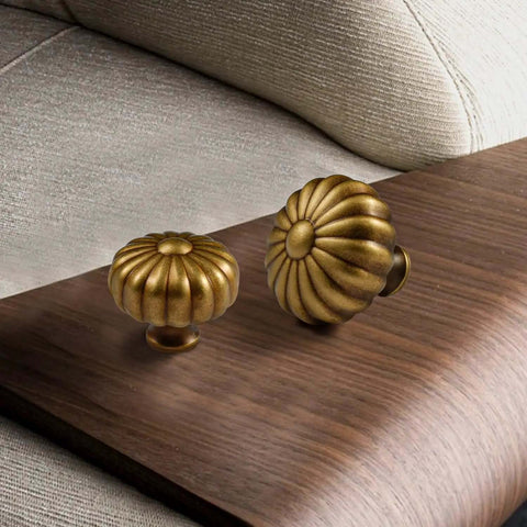 Four Pack Solid Brass Pumpkin Cabinet Knobs For Kitchen Drawers And Dressers Vintage Antique Copper Hardware on wood surface.