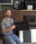 Man holding black ABS plastic Crawl Space Recessed Vent Cover for 8 By 16 Inch Openings in showroom display.