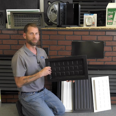 Man holding black ABS plastic Crawl Space Recessed Vent Cover for 8 By 16 Inch Openings in showroom display.