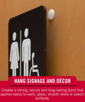 Top Notch Peel And Stick Hook And Loop Fastener Dots Beige Medium Three Quarter Inch Circles on wall holding a sign securely.