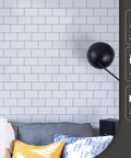 Premium Peel And Stick Tile Backsplash Kit, 12 By 12 Inch Tiles, 10 Pack for Kitchen Walls, Bright White, installed behind sofa