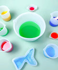 Ultimate Resin DIY Kit Silicone Measuring Cups Set With 600ml And 100ml Mixing Cups and colorful epoxy mix in molds.