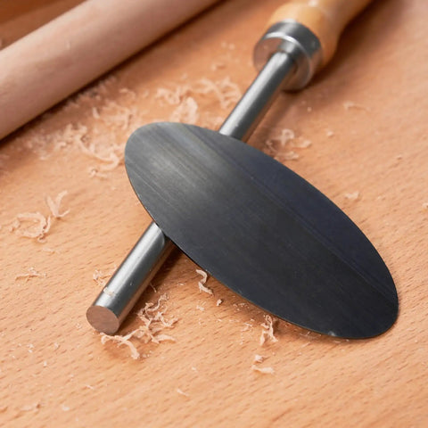 Top Shelf Six Piece Cabinet Scraper And Burnisher Kit With Blue Spring Steel Blades Plus Hardened High Speed Steel Sharpening Rod For Knockout Woodworking Finishes Daily, steel scraper blade on wooden surface.