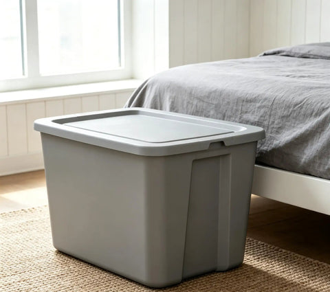 Straight Up Tough As Nails Heavy Duty Plastic Storage Bin With Secure Snap On Lid For Real Garage Setup Or Home Decluttering Projects Gray 18 Gallon Capacity next to bed in a bedroom.