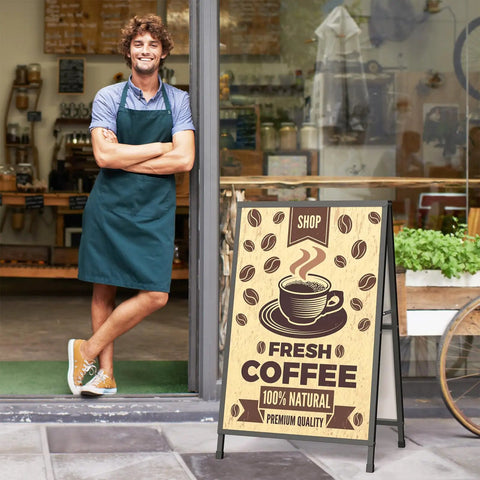 Heavy Duty 24x36 Outdoor A Frame Signs Double Sided Sandwich Board For Outside Use All Weather Wind Resistant Sidewalk Display Frame Sturdy Iron Frame With Easy Push In Design For Businesses outside a coffee shop.