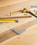 Stainless Steel L Shaped Brackets For Furniture Frames And Wood Shelves With Slotted Design 20 Pack shown on wooden table with tools