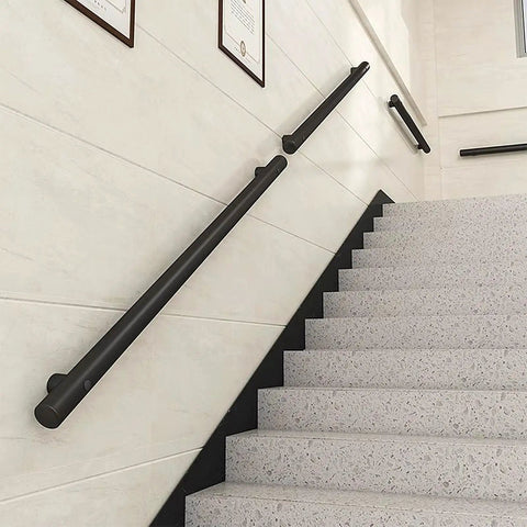 Badass Stainless Steel Railing Slick Black Metal Balusters mounted on wall by stairs for safety and modern design.