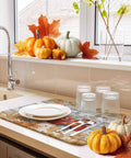 Set Of 2 Absorbent Microfiber Dish Drying Mats For Kitchen Counter 16 X 18 Inches Machine Washable Fall Autumn Thanksgiving Sunflower Red Truck Wood Grain Design Cozy Holiday Decor And Durable Non Slip Pad in use beside pumpkins and plates.