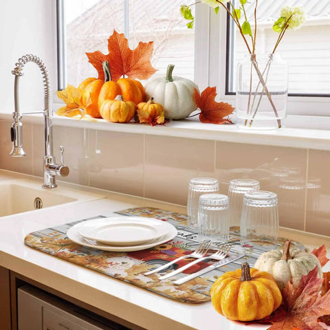 Set Of 2 Absorbent Microfiber Dish Drying Mats For Kitchen Counter 16 X 18 Inches Machine Washable Fall Autumn Thanksgiving Sunflower Red Truck Wood Grain Design Cozy Holiday Decor And Durable Non Slip Pad in use beside pumpkins and plates.
