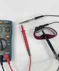 Anti Static Wrist Strap Band With Grounding Wire For ESD and multimeter on white surface.