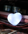 Illuminated heart-shaped purse light inside a handbag, part of Two Pack Heart Shape Purse Lights With Sensor Illuminator For Handbags.