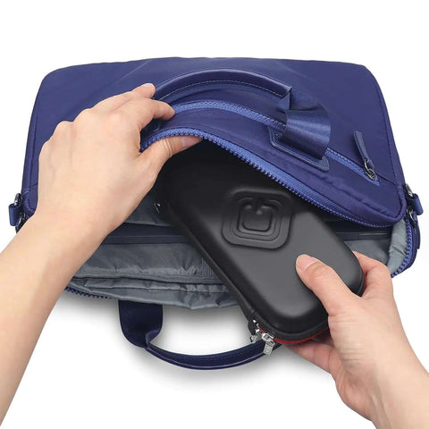 Person inserting a black Slick Flash Drive Case and USB Stick Organizer for Keeping Thumb Drives Locked Down Tight During Everyday Commutes into a blue laptop bag.