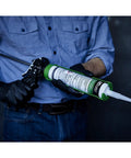 Fluid Applied STPE Liquid Flashing Sealant In 29 Oz Cartridge For Rough Openings And Door Window Installations held in gloved hand.