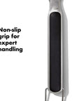 Close-up of Grilling Tool Precision Turner with a black non-slip grip handle and stainless steel, OXO Good Grips Black.