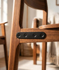 Built Tough Black Stainless Steel Mending Plates With Full Screw Kit installed on a wooden chair for support and stabilization.