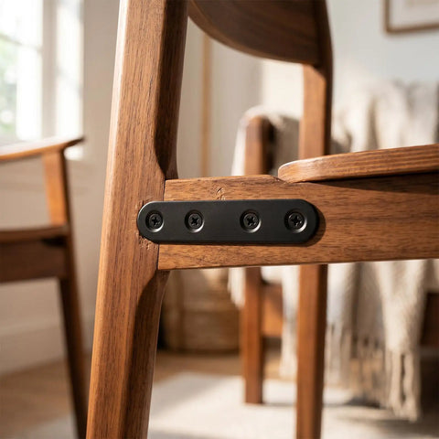 Built Tough Black Stainless Steel Mending Plates With Full Screw Kit installed on a wooden chair for support and stabilization.