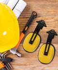 Kickass Heavy Duty Construction Hard Hat With Integrated Noise Cancelling Ear Muffs For Industrial Work Sites And Adjustable Hearing Protection with yellow earmuffs and tools.