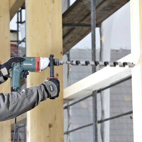 Heavy Duty One Half Inch High Torque Drill With Solid Six Point Seven Amp Motor and Wide Speed Range from Zero to Six Hundred Fifty Rpm drilling into wood beams