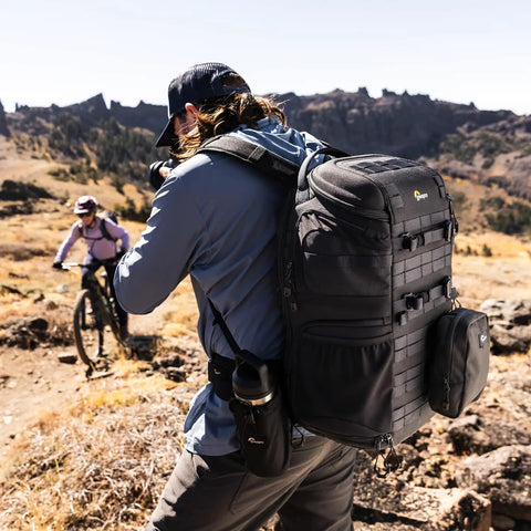 Person with ProTactic BP 450 AW III Camera Backpack With 4 Point Quick Access Versatile DSLR Mirrorless And Drone Gear in outdoor setting