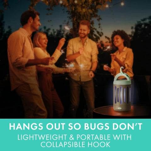 Group enjoying outdoor gathering near 360 Degree UV Bug Zapper For Indoor And Outdoor Use on table at night