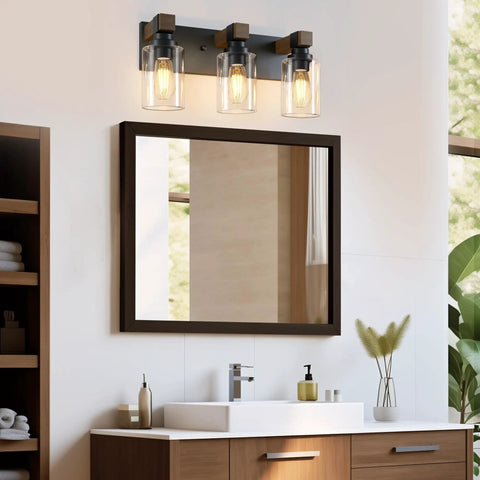 Give Your Mirror Space A Major Glow Up With This Three Bulb Bathroom Vanity Light In Matte Black And Raw Wood Grain Secured By Rock Solid Steel Mounts For Straight Up Rustic Charm above a mirror.