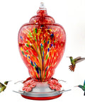 Colorful Hand Blown Glass Hummingbird Feeder For Outdoors Patio Large 32 Ounce With Ant Moat Hanging Hook Rope Cleaning Brush And Service Card Red Firework close-up with hummingbirds feeding