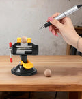 Portable Aluminum Alloy Drill Press Vise With Suction Base, Table Bench Clamp For Jewelry Making And Hobby Crafts, Small Parts Holding, Mini Workbench Vise For Workshop, Lightweight Yet Rugged And Easy Mount. 180° base on wooden table holding a small ball