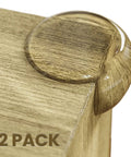 Rock Solid Table Corner Protectors And Clear Edge Guards For Baby Proofing Furniture Safety With Heavy Duty Tape on a wooden table edge.
