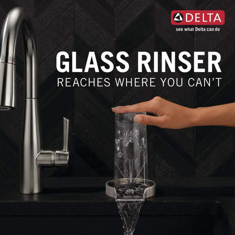 Hand using Chrome Glass Rinser For Kitchen Sink GR250 with powerful water jets on clear glass in modern kitchen.