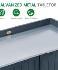 Galvanized metal tabletop of outdoor storage cabinet with potting bench for garden and patio, showcasing weatherproof features.