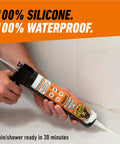 Gorilla 100% silicone sealant cartridge in white being applied with a caulk gun on tiled bathroom surface.
