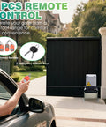 Person using remote to operate Beefy 750W Automatic Sliding Gate Opener Kit with app control and remotes in driveway.