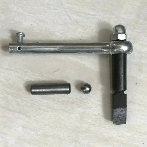 Top view of clutch repair kit components: chrome mounting rod with bolt, black shifting shaft, pin and ball