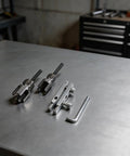 2 Piece Pipe Threading Tool Kit With Hex Die Design And Broken Wire Extractor For Quick Jam Free Internal And External Threading On PVC And Metal Pipes A Real Workhorse For Home Pro Jobs And DIY Enthusiasts., two metal pipe threading dies with extractor and hex key on workbench