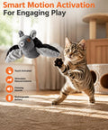 Flying Bat Dog Toy With Motion Activated Rechargeable Power, Interactive Indoor Outdoor Toy For Cats And Dogs With Realistic Flapping Wings And Pet Hair Removal Glove, gray plush bat toy beside kitten