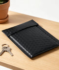 100 Pack 5 By 6 Inch Black Poly Bubble Mailers Self Seal Padded Envelopes next to keys on wooden table
