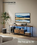 No Sweat Setup Industrial TV Stand With Built In Power Outlets And Chill Led Ambiance Lighting, 70 Inch Media Console For Massive Screens Living Room Storage Shelves Rustic Brown in a modern living room setting.